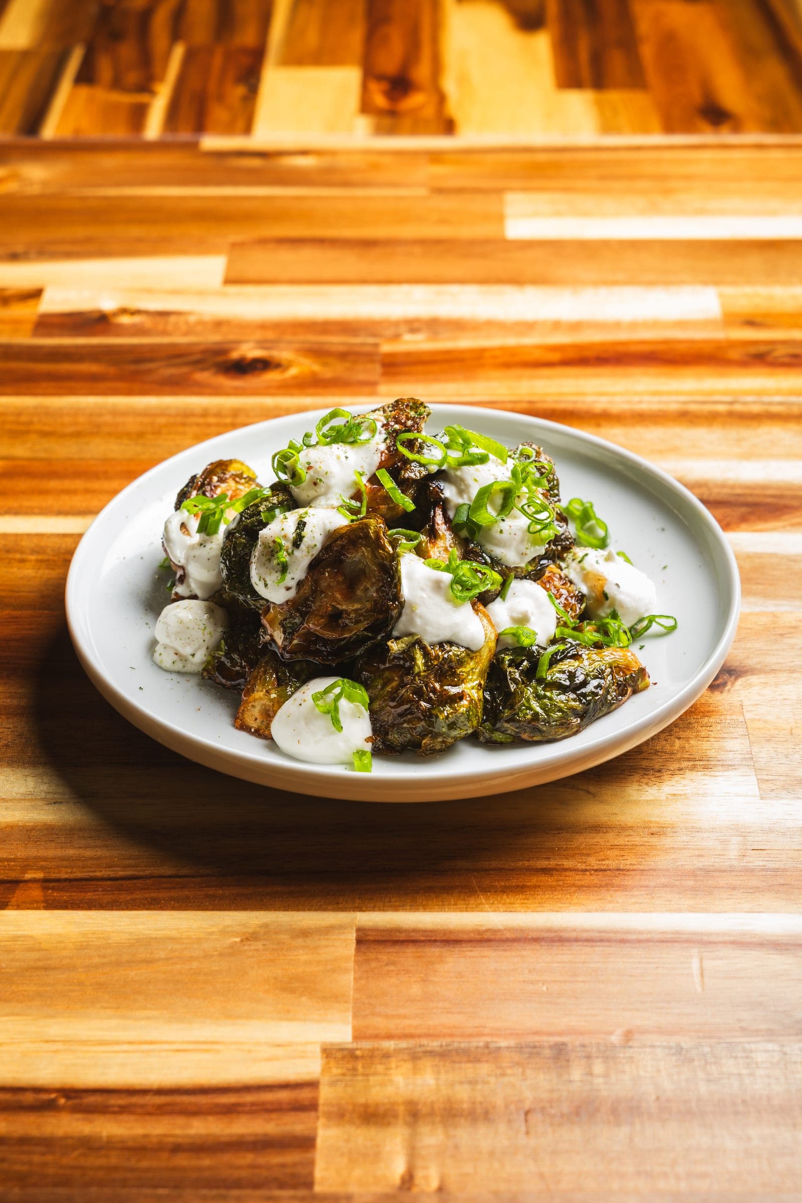 Tender meatballs over dressed greens