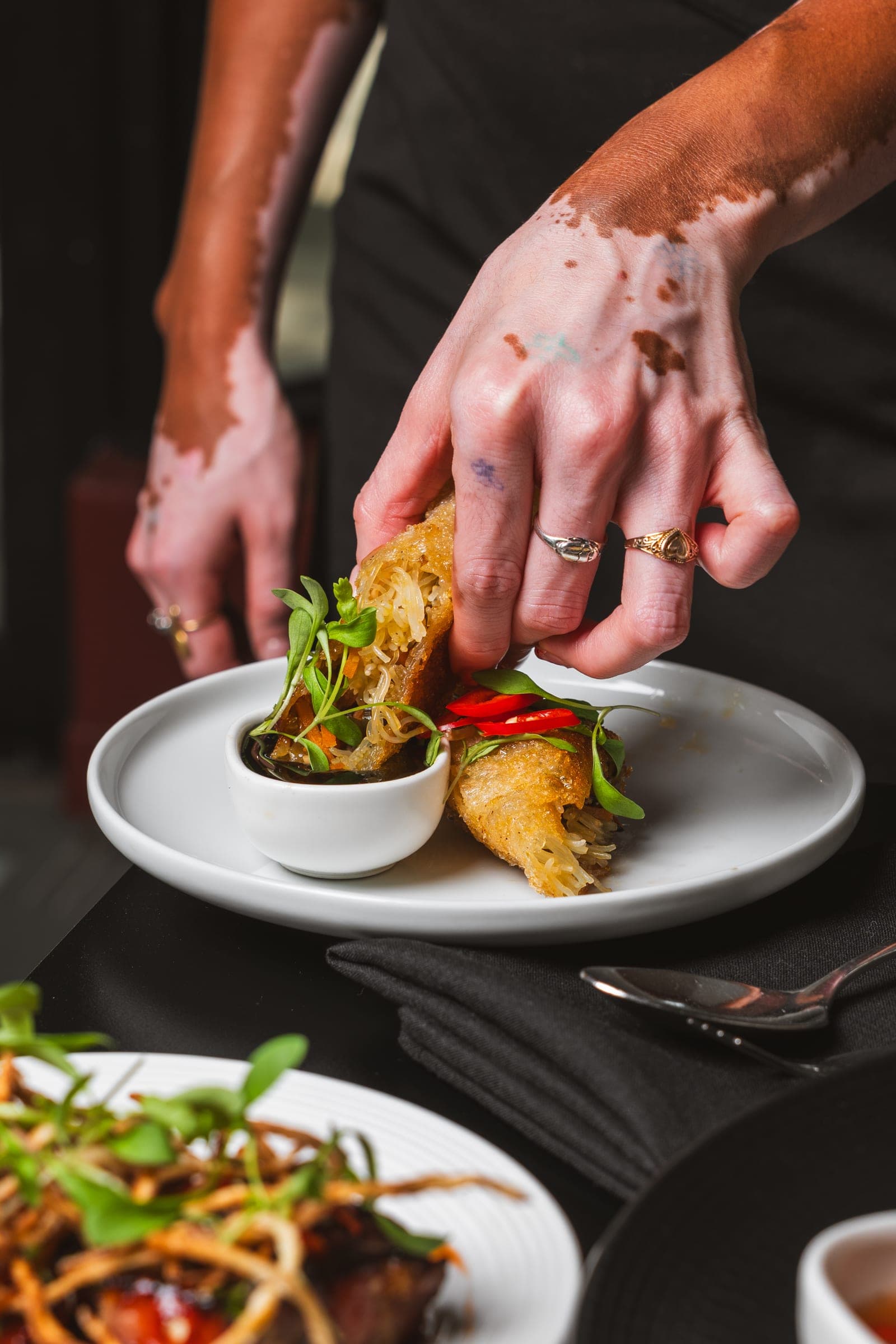 A chef finishing a dish tableside