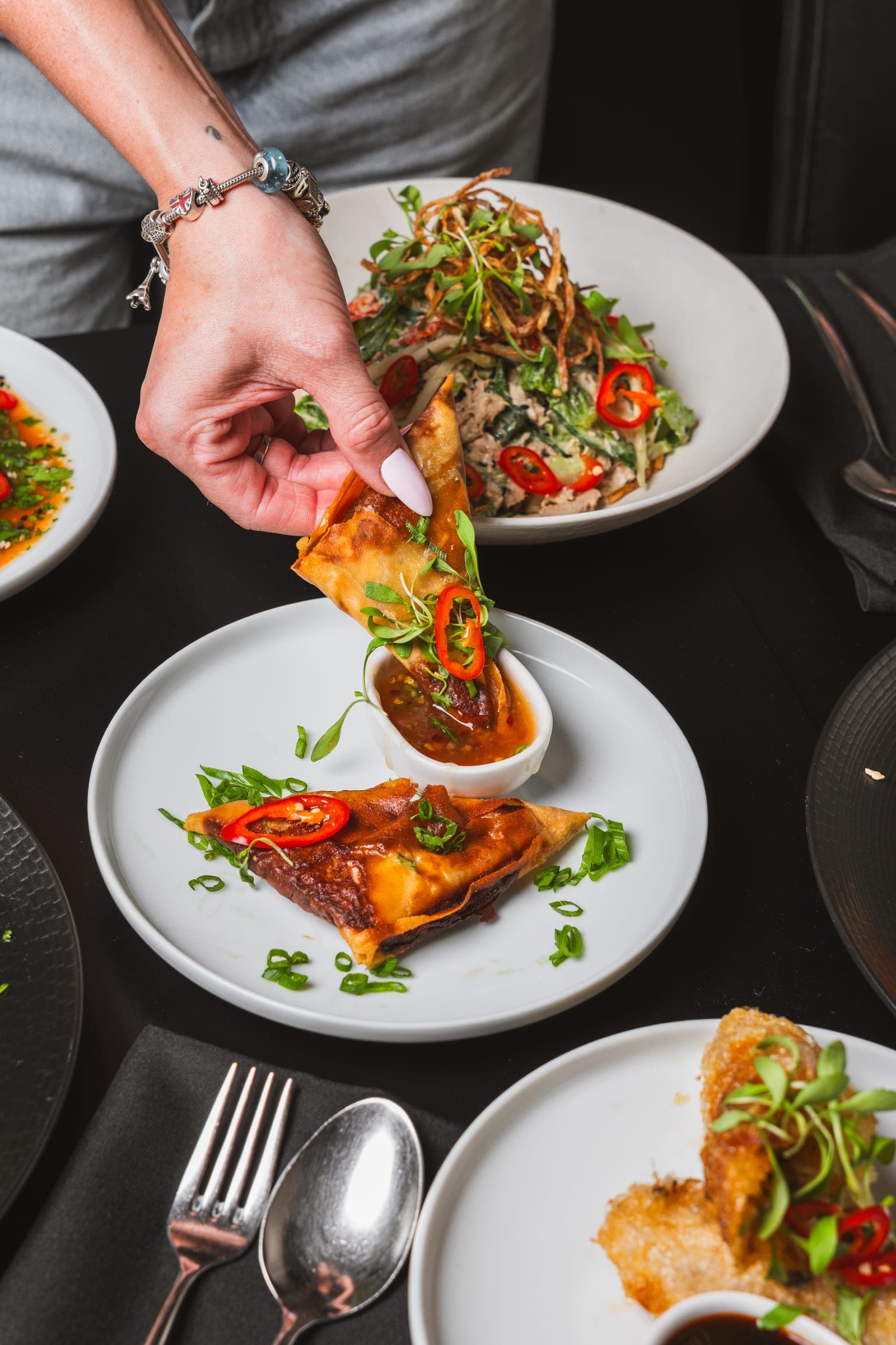 A chef plating a dish at 'noy