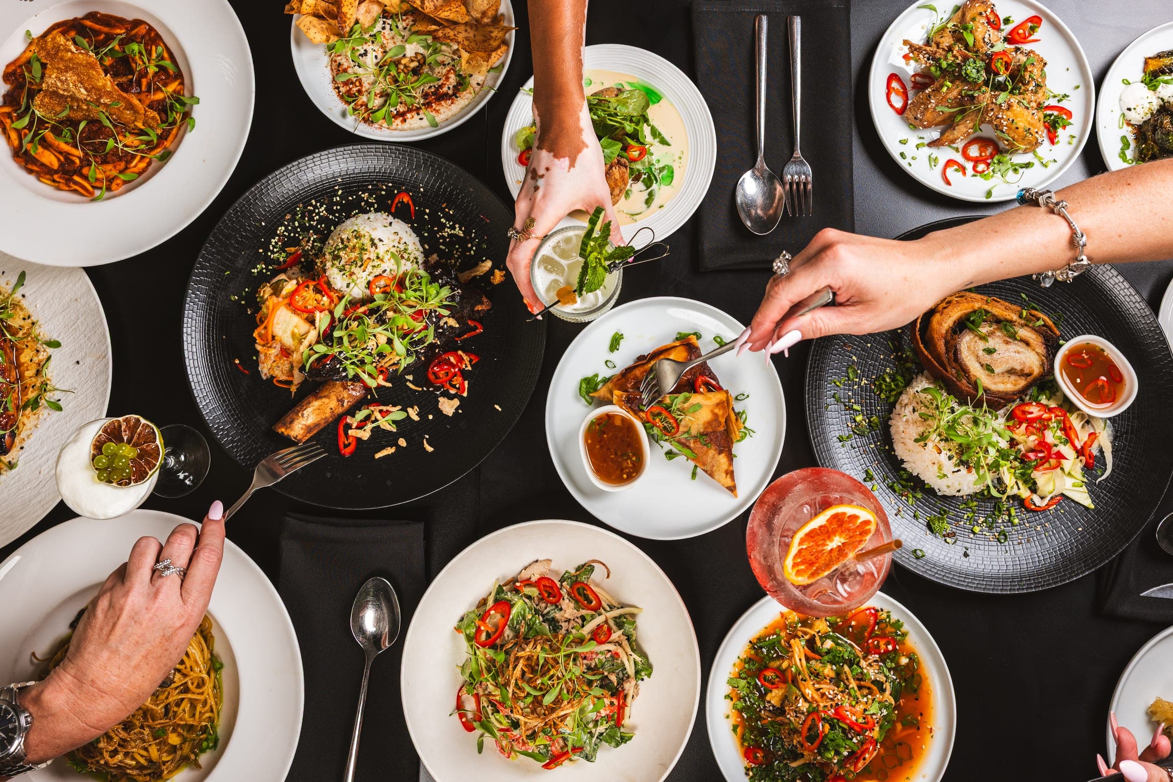 A table of shared plates at 'noy Asian Snack Bar